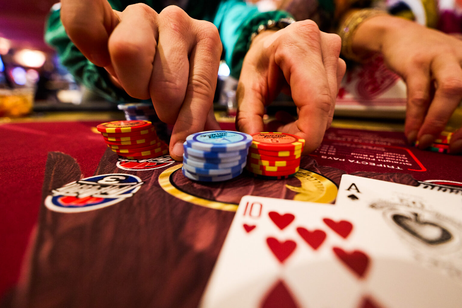 close up of cards and chips on a velvet table top game